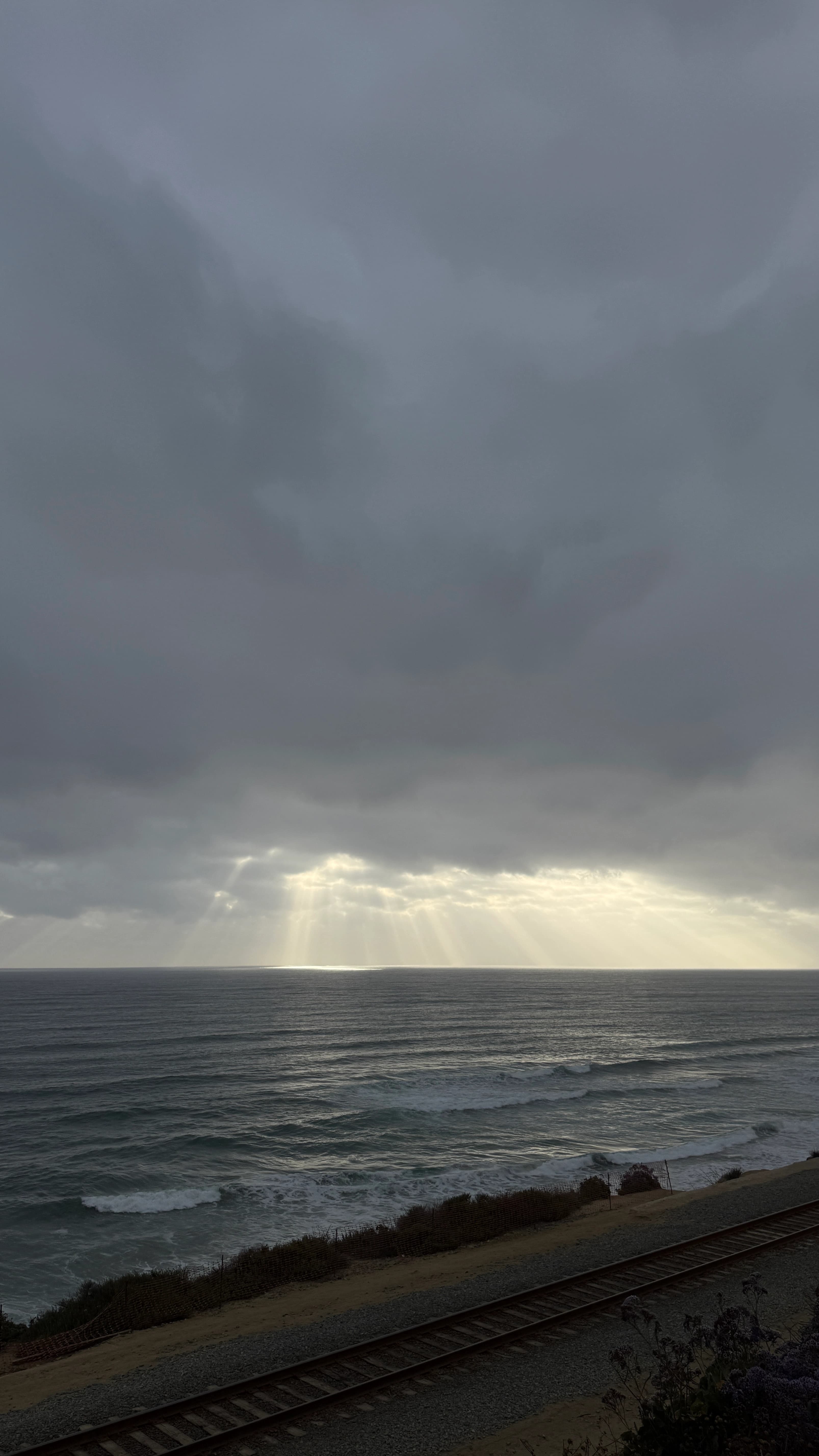 Sun coming through the clouds along the horizon